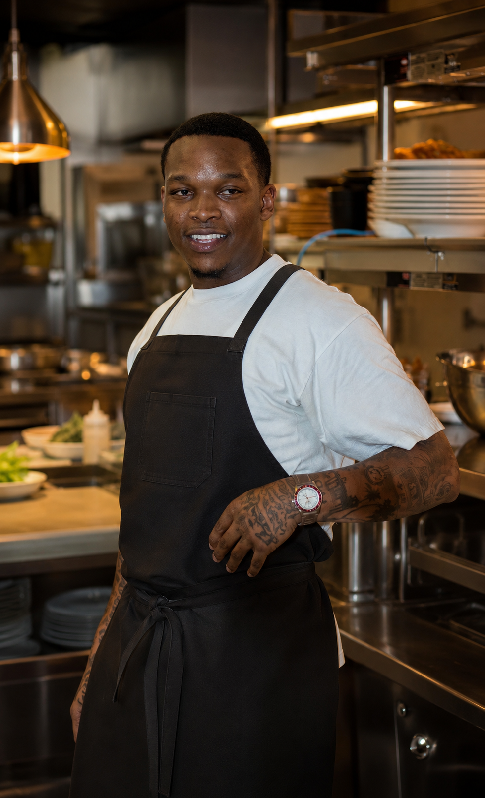Gabriel Cerease, executive chef of 1123 Miami, in a black apron on the kitchen line